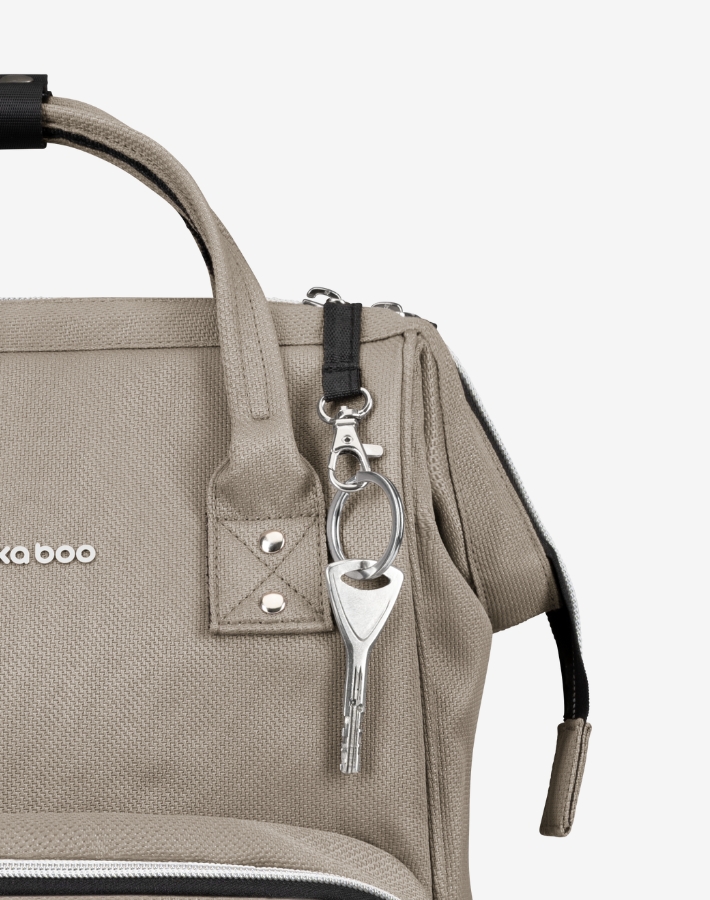 A convenient key chain holder is included in the bag, ensuring your keys are always accessible and secure, a small detail that makes a big difference in daily convenience.